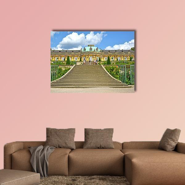 Sanssouci Palace Staircase and Gardens Canvas Wall Art in yellow, green and blue, single panel hung on a wall