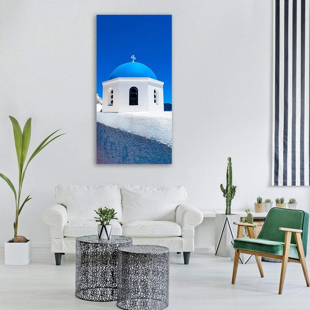 Santorini Blue Dome Church Vertical Canvas Wall Art in white and blue, single vertical panel hung on a wall