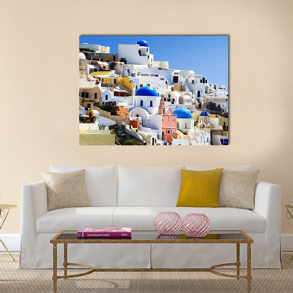 Santorini Island Village of Oia Canvas Wall Art in white and blue, single panel hung on a wall