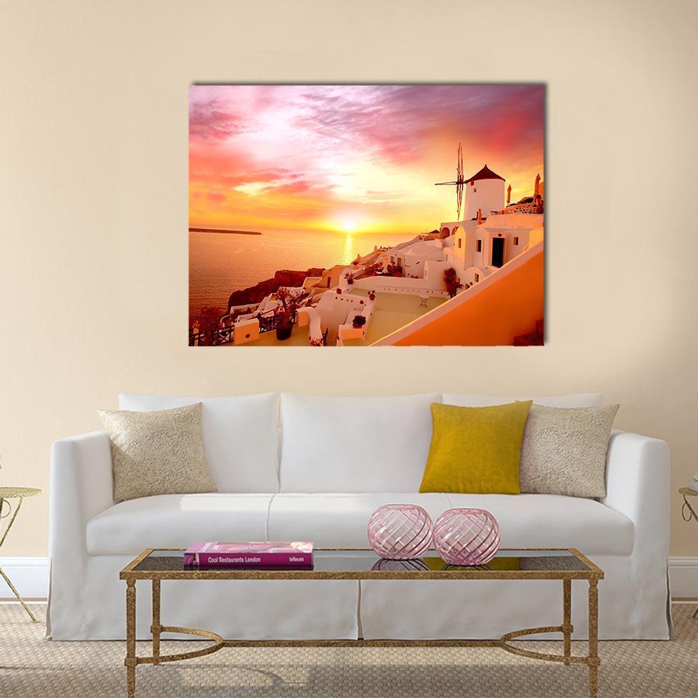 Santorini Sunset with Windmill in Greece Canvas Wall Art in orange, yellow and pink, single panel hung on a wall