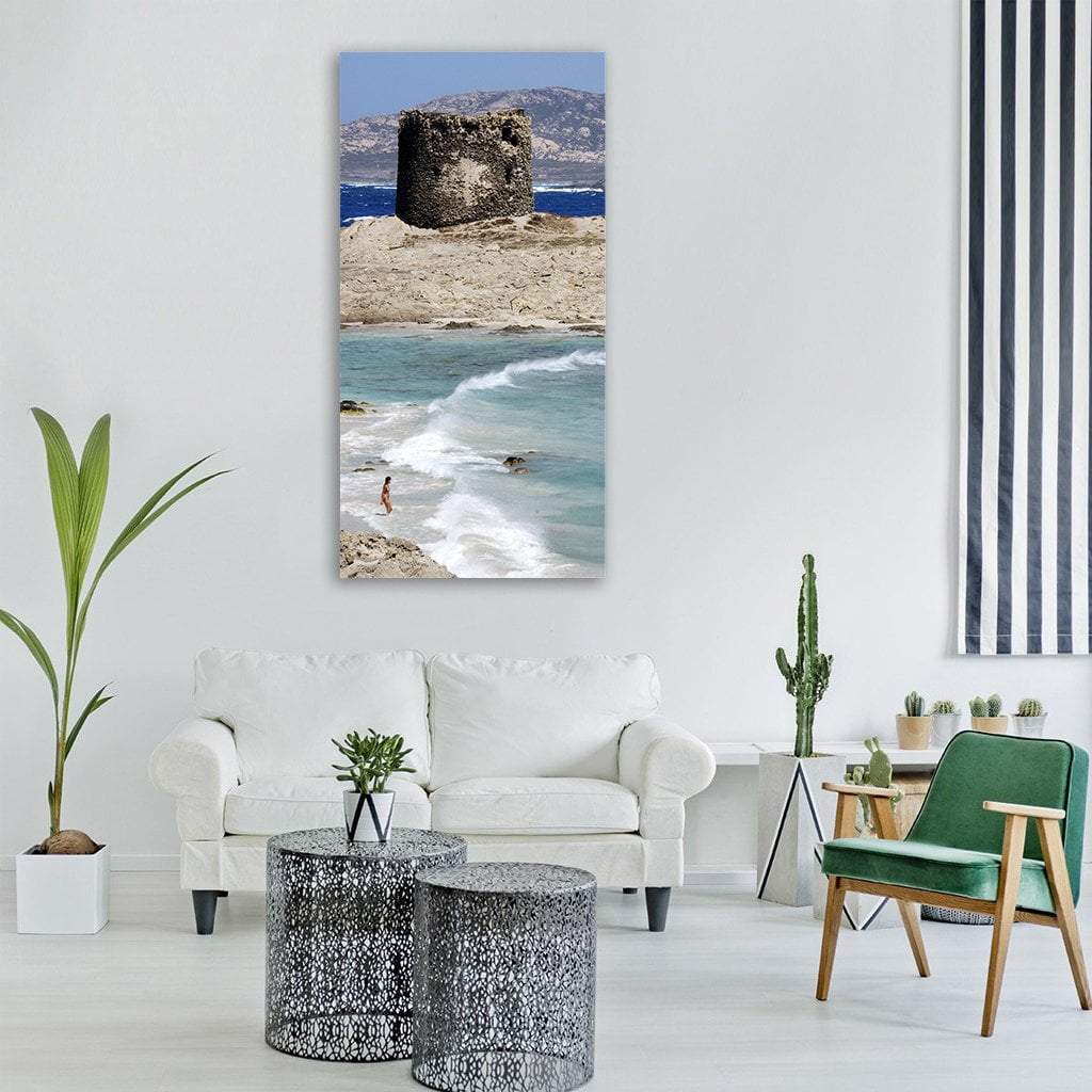 Sardinia Beach with Stone Tower Vertical Canvas Wall Art in gray, beige and blue, single vertical panel hung on a wall