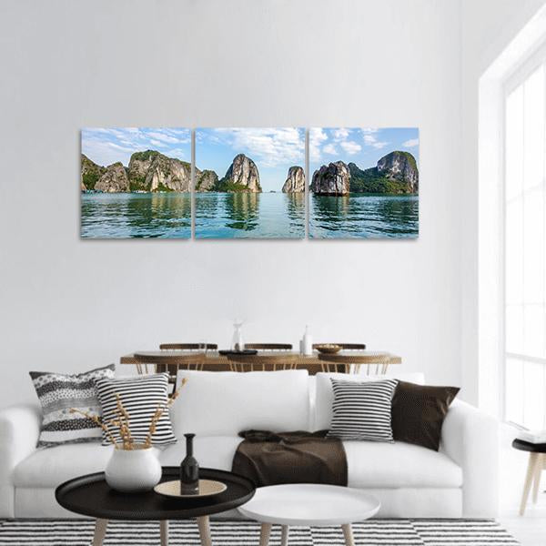 Halong Bay Limestone Karsts with Reflections Panoramic Canvas Wall Art in gray, green and blue, hung on a wall