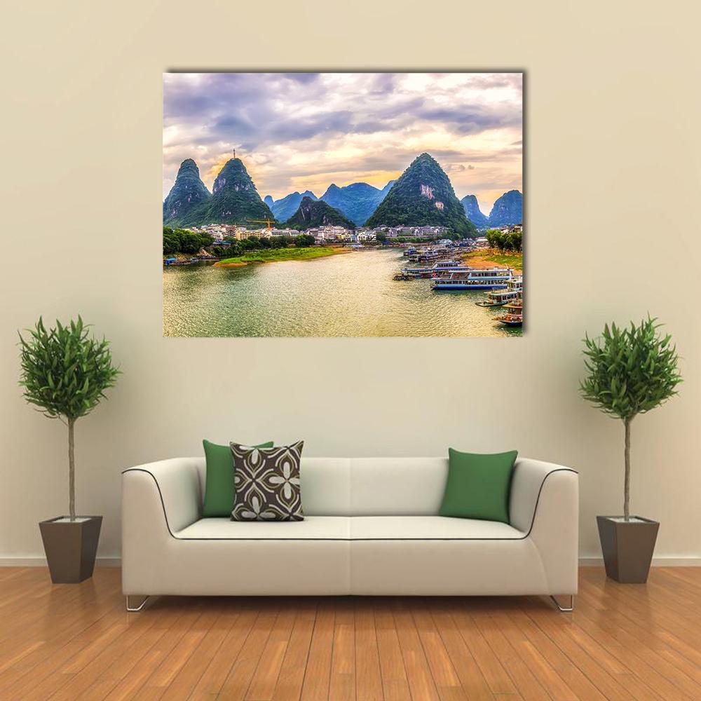 Karst Mountains and River at Sunset Canvas Wall Art in yellow, green and blue, single panel hung on a wall