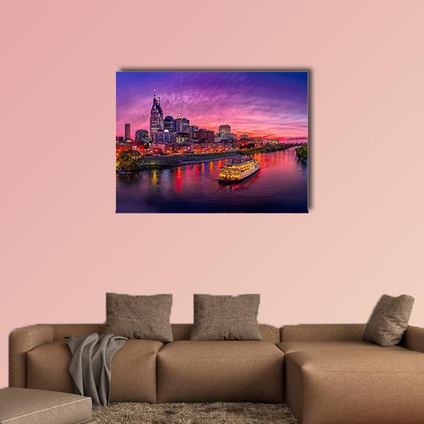Nashville Skyline at Sunset with Paddlewheel Boat Canvas Wall Art in blue, purple and pink, single panel hung on a wall