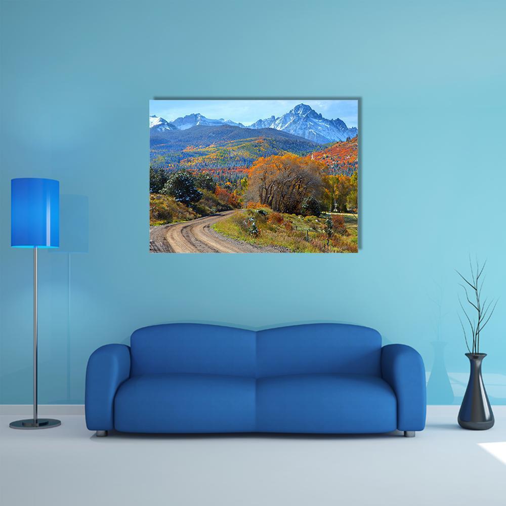 Ridgeway Colorado Autumn Mountain Road Canvas Wall Art in orange, yellow and blue, single panel hung on a wall