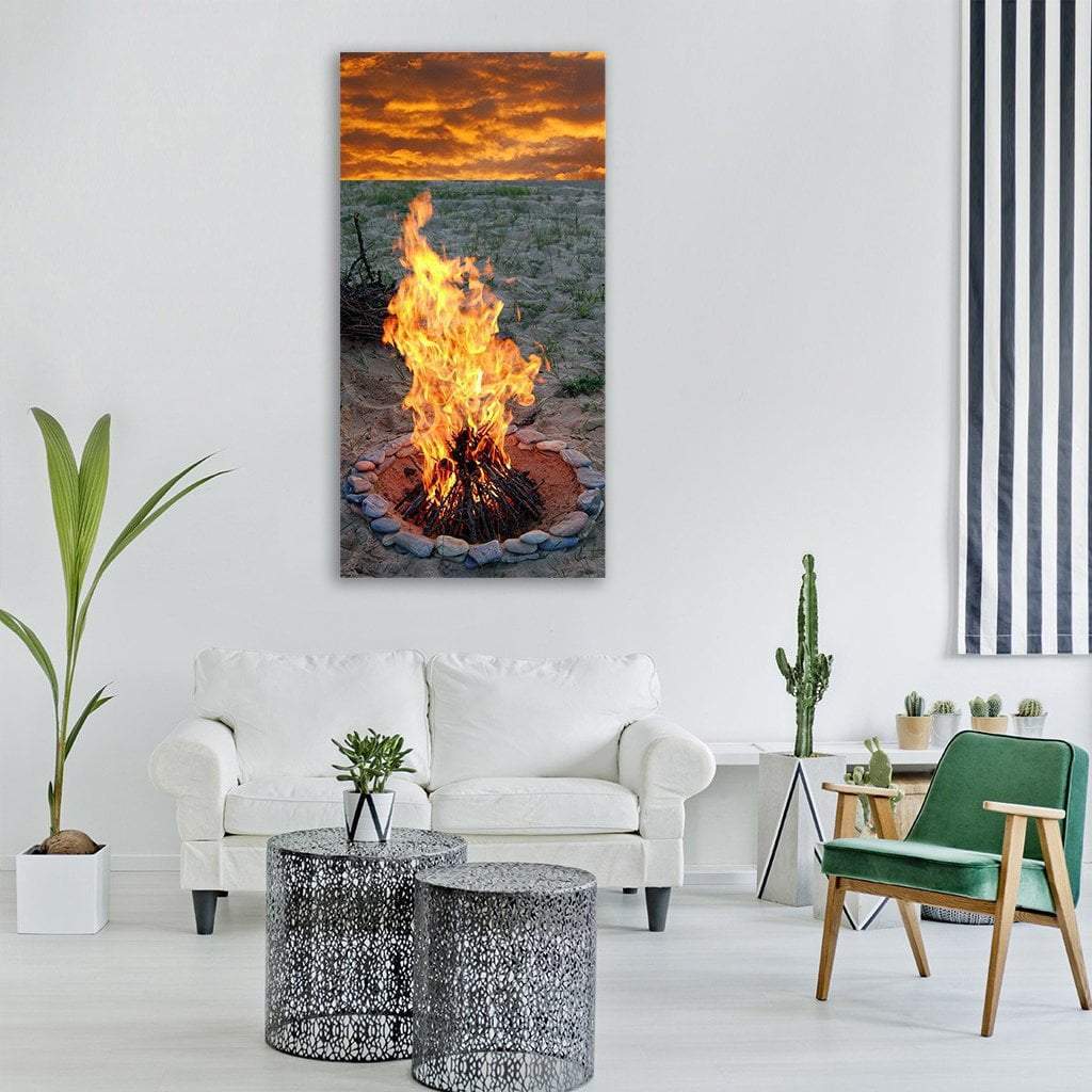 Scenic Campfire at Sunset Vertical Canvas Wall Art in gray, orange and yellow, single vertical panel hung on a wall
