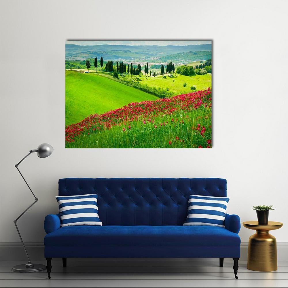 Tuscan Hill Landscape Canvas Wall Art in red, green and blue, single panel hung on a wall