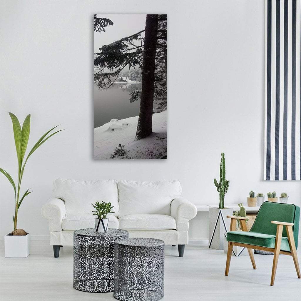 Winter Lake with Snow-laden Tree Vertical Canvas Wall Art in black, white and gray, single vertical panel hung on a wall