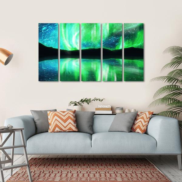 Northern Lights with Mountain Reflection Canvas Wall Art in black, green and blue, hung on a wall