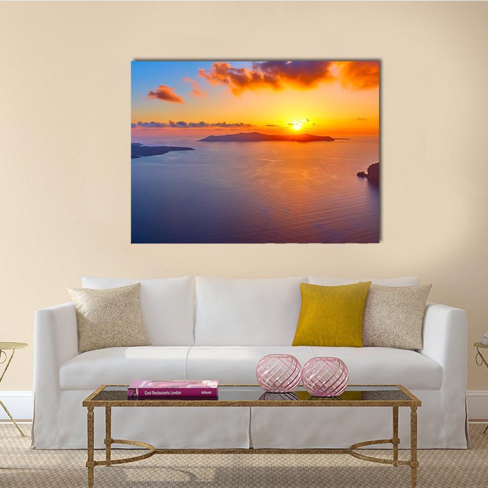 Santorini Sunset Over Sea Canvas Wall Art in orange, yellow and blue, single panel hung on a wall