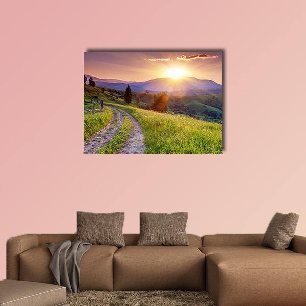 Sunset Path Through Mountain Meadow Canvas Wall Art in orange, green and purple, single panel hung on a wall