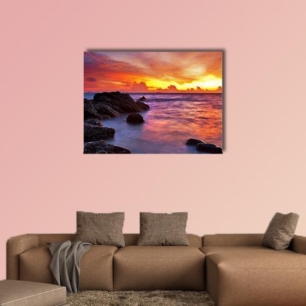 Tropical Beach at Sunset Canvas Wall Art in orange, yellow and purple, single panel hung on a wall