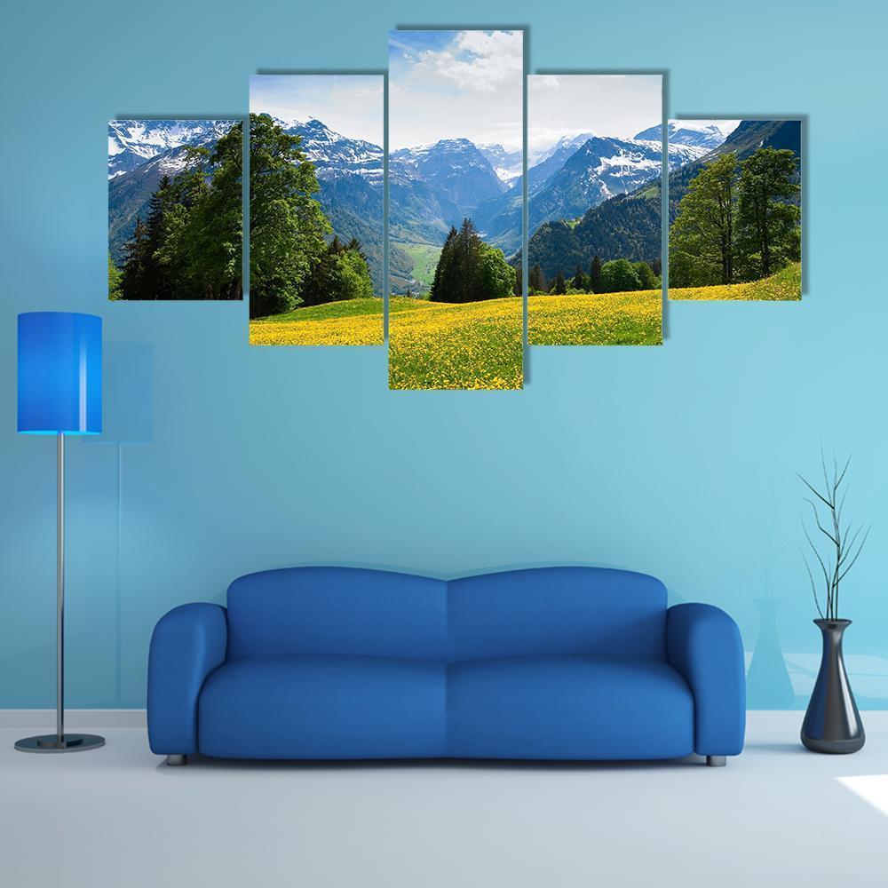 Scenic View from Braunwald in Spring Canvas Wall Art in yellow, green and blue, 5 panel Star layout hung on a wall