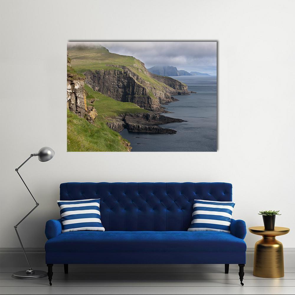 Mykines Coastal Cliffs and Misty Sea Canvas Wall Art in gray, green and blue, single panel hung on a wall