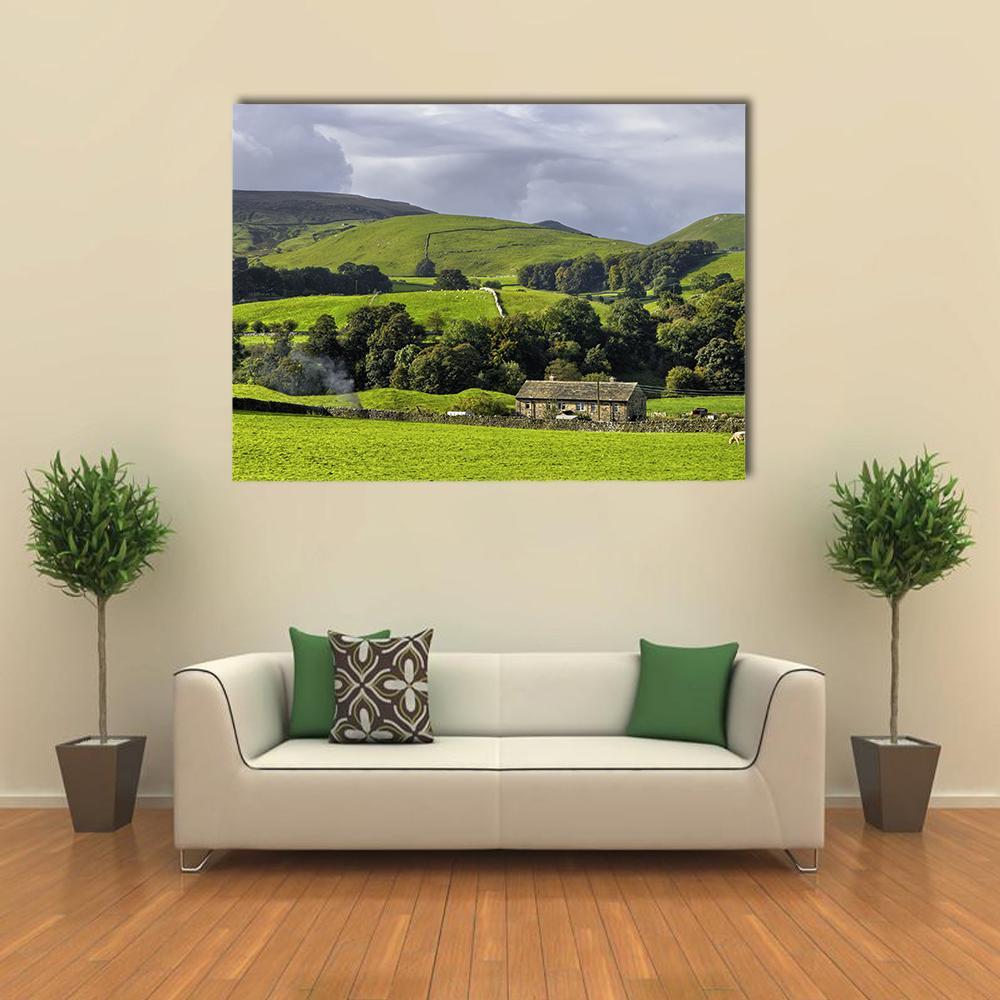 Stone Farmhouse in Rolling Hills Canvas Wall Art in gray, green and blue, single panel hung on a wall