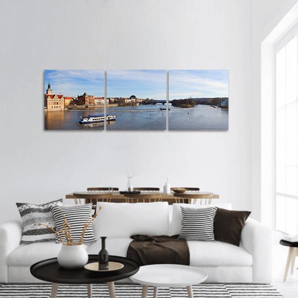 Prague Riverfront with Stone Bridge Panoramic Canvas Wall Art in white, brown and blue, hung on a wall