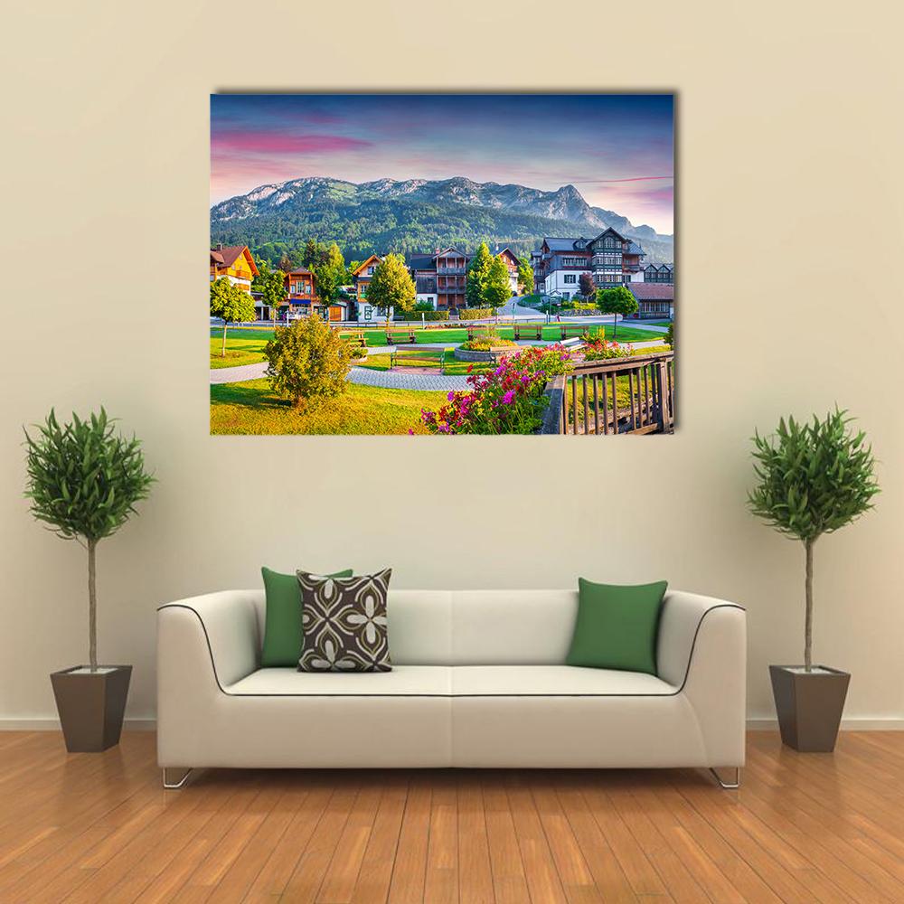 Alpine Village with Pink-tinged Sky Austria Canvas Wall Art in green, blue and pink, single panel hung on a wall