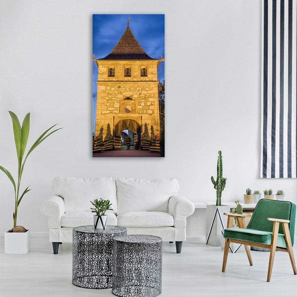 Schloss Laufen Castle at Twilight Vertical Canvas Wall Art in gold, yellow and blue, single vertical panel hung on a wall