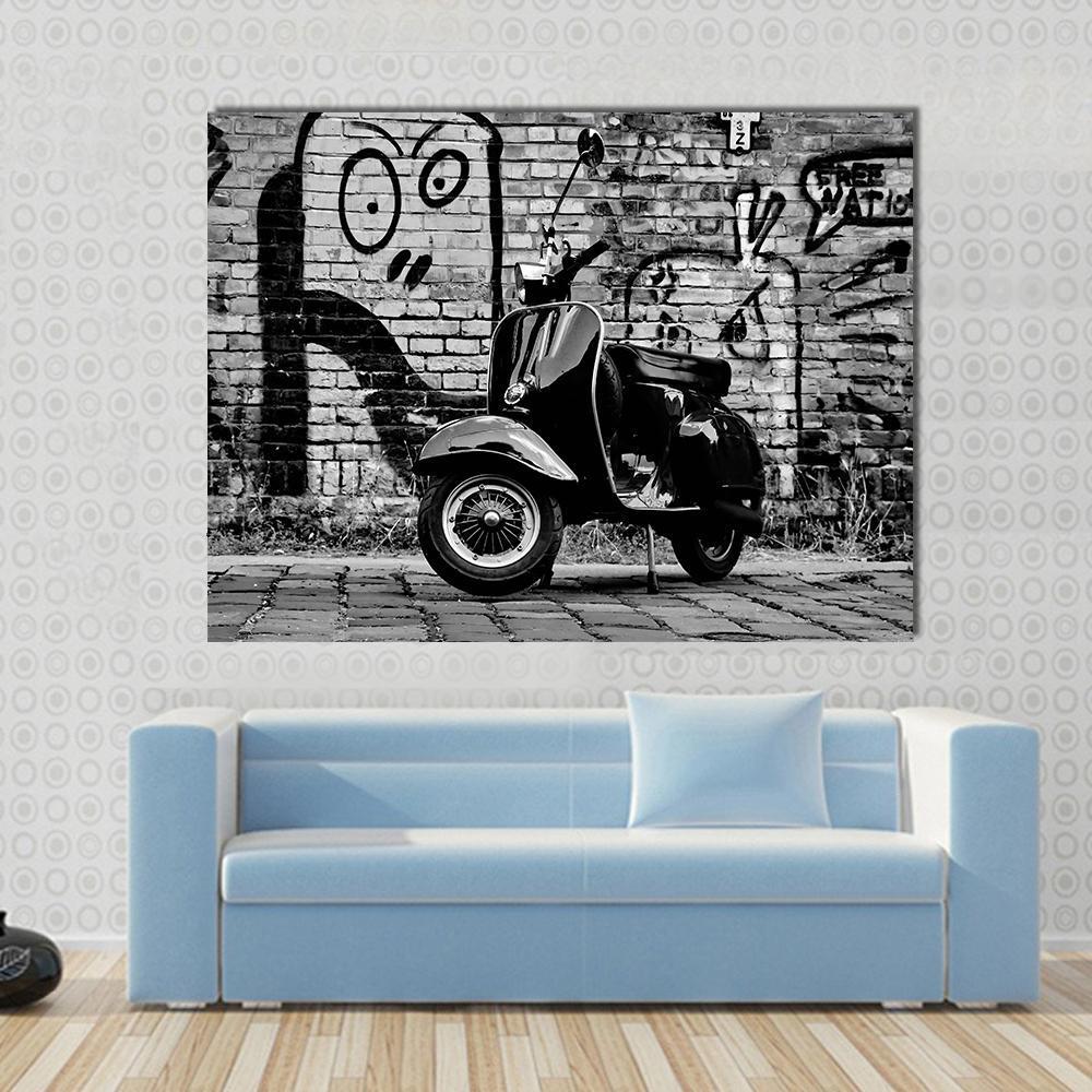 Scooter in Front of A Canvas Wall Art in black, white and gray, single panel hung on a wall