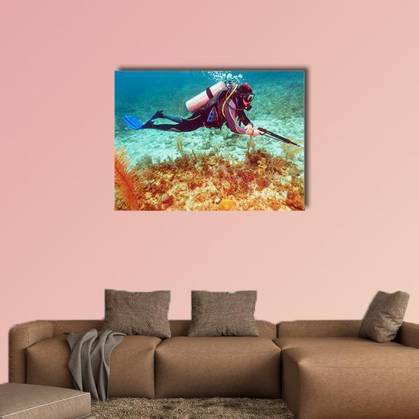 Scuba Diver Near Coral Bottom Canvas Wall Art in beige, brown and blue, single panel hung on a wall