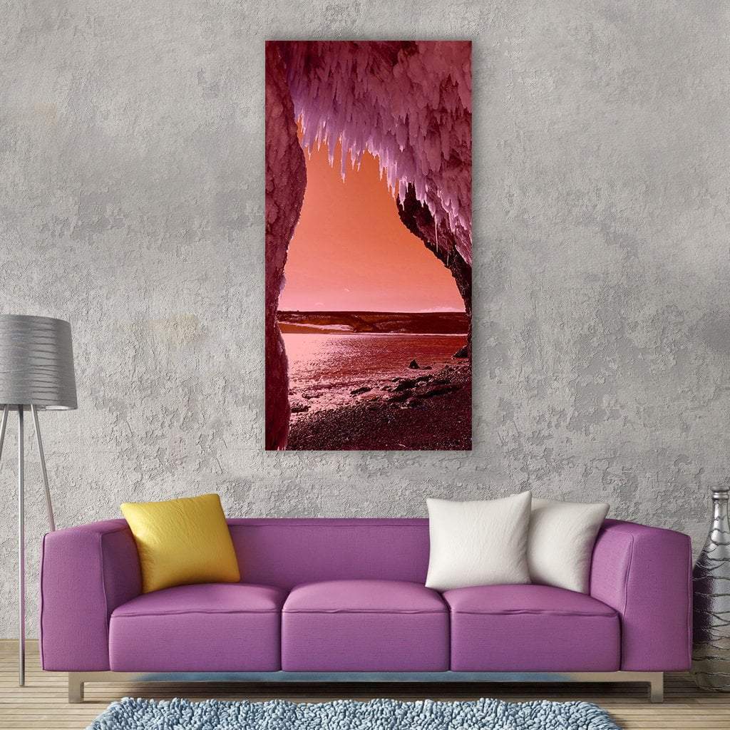 Winter Beach Cave with Icicles Vertical Canvas Wall Art in red, orange and pink, single vertical panel hung on a wall