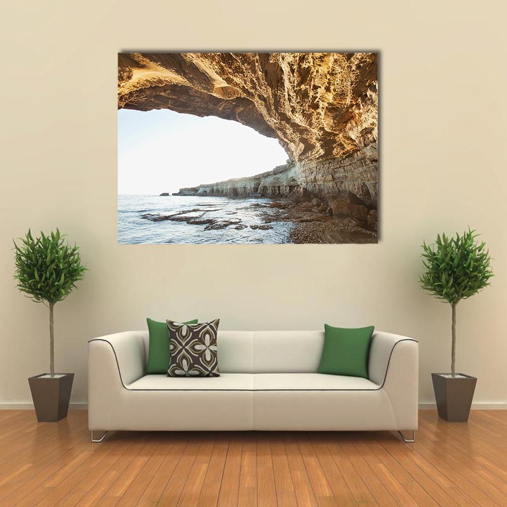 Sea Caves of Cavo Greco Canvas Wall Art in beige, brown and blue, single panel hung on a wall