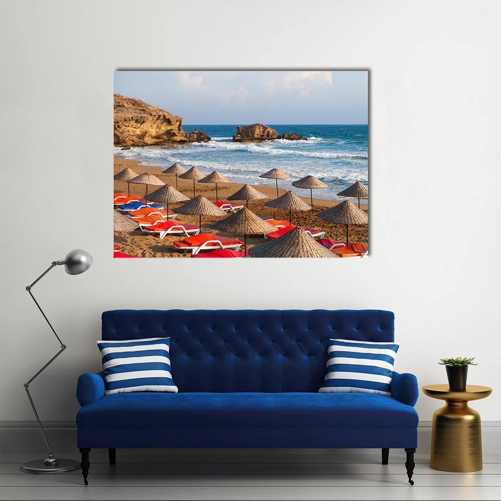 Cyprus Beach with Straw Umbrellas Canvas Wall Art in beige, brown and blue, single panel hung on a wall