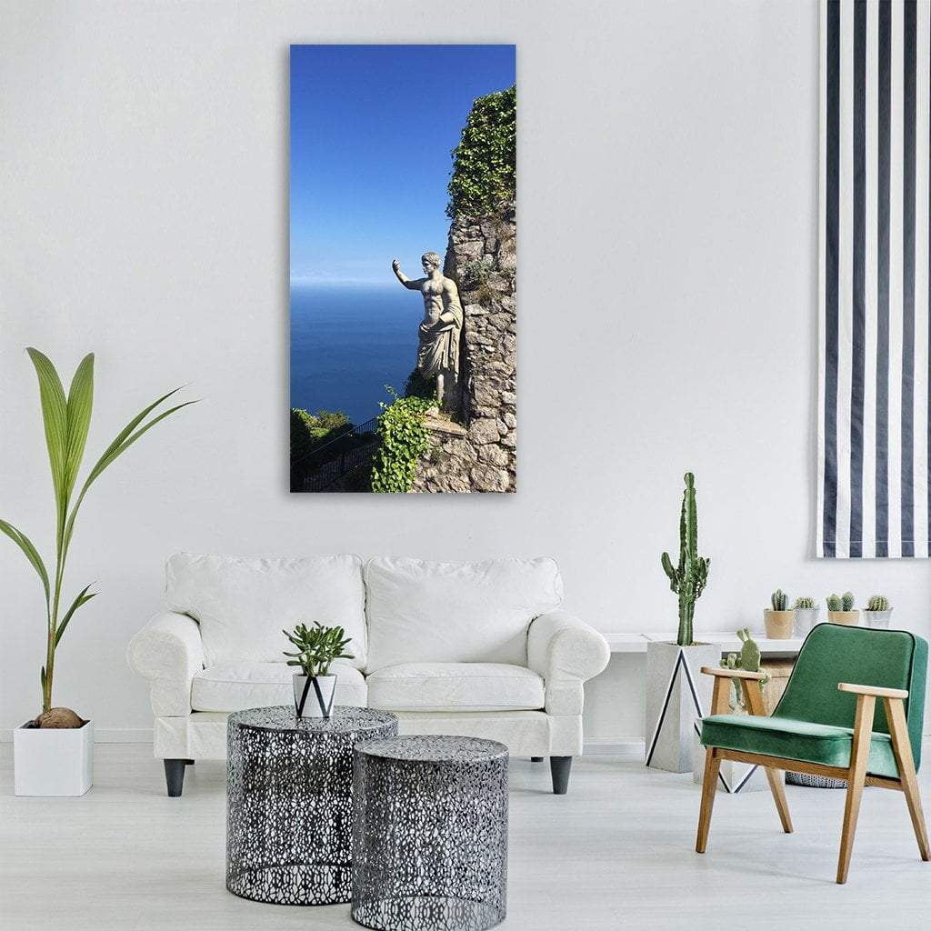 Greco-roman Statue on Coastal Cliff Vertical Canvas Wall Art in gray, green and blue, single vertical panel hung on a wall