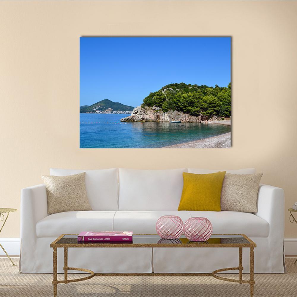 Sunny Sea View with Pebble Beach and White Boat Canvas Wall Art in gray, green and blue, single panel hung on a wall