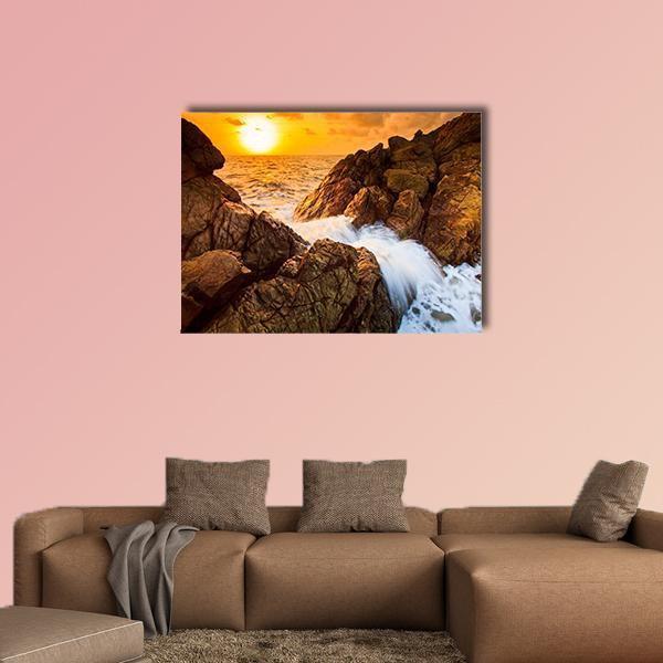 Waves Crashing on Rocky Shore at Sunset Canvas Wall Art in brown, orange and yellow, single panel hung on a wall
