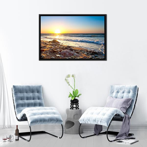 Sunset Seascape with Pebble Shore Canvas Wall Art in orange, yellow and blue, framed canvas, product view on a white background