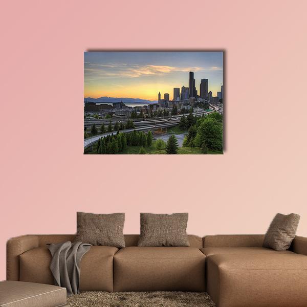 Seattle Skyline with Mountains at Sunset Canvas Wall Art in orange, green and blue, single panel hung on a wall