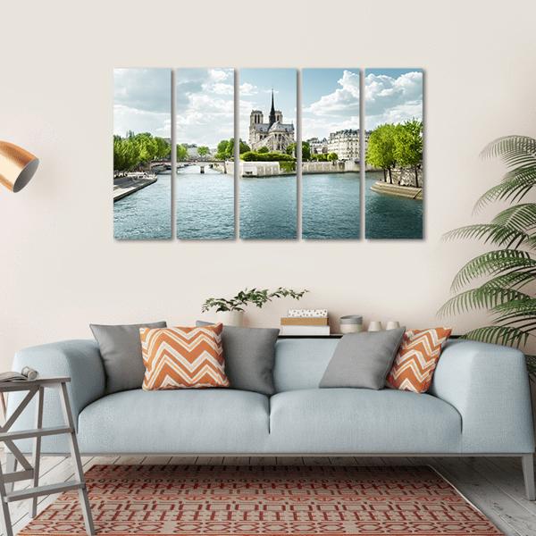 Notre Dame Cathedral and the Seine Canvas Wall Art in white, green and blue, hung on a wall