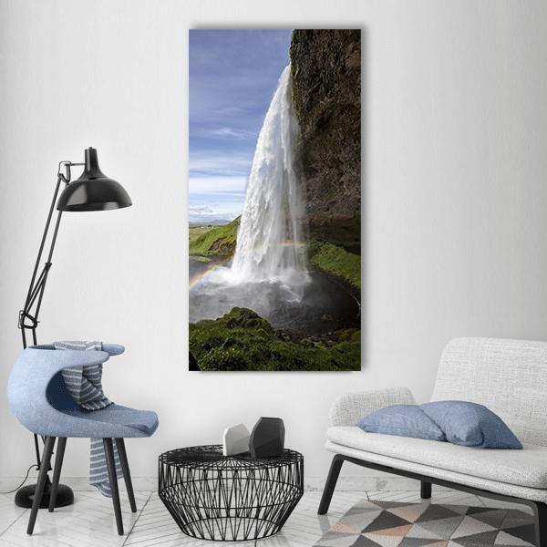 Seljalandsfoss Waterfall in Iceland Vertical Canvas Wall Art in white, green and blue, single vertical panel hung on a wall