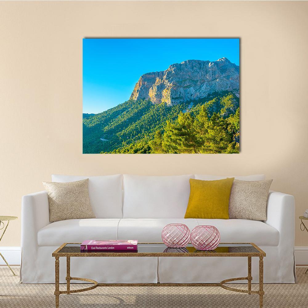 Winding Mountain Road Landscape Canvas Wall Art in brown, green and blue, single panel hung on a wall