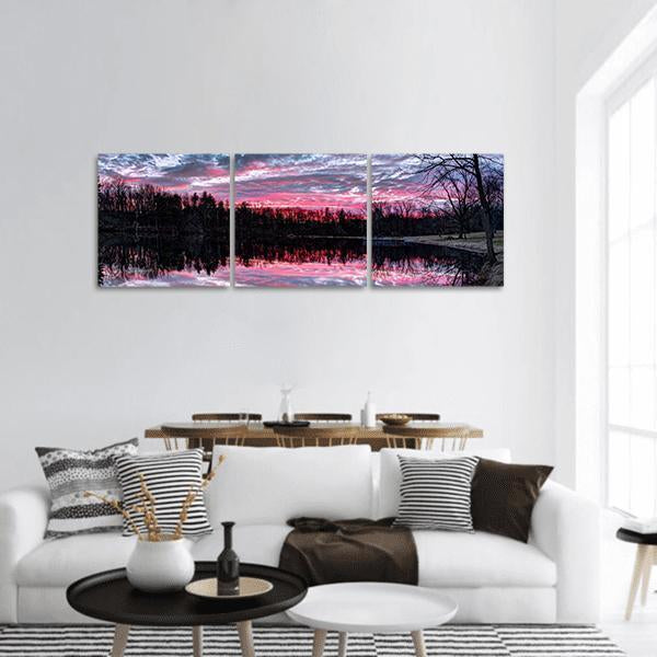 Winter Sunset Over Small Pond Panoramic Canvas Wall Art in black, purple and pink, hung on a wall