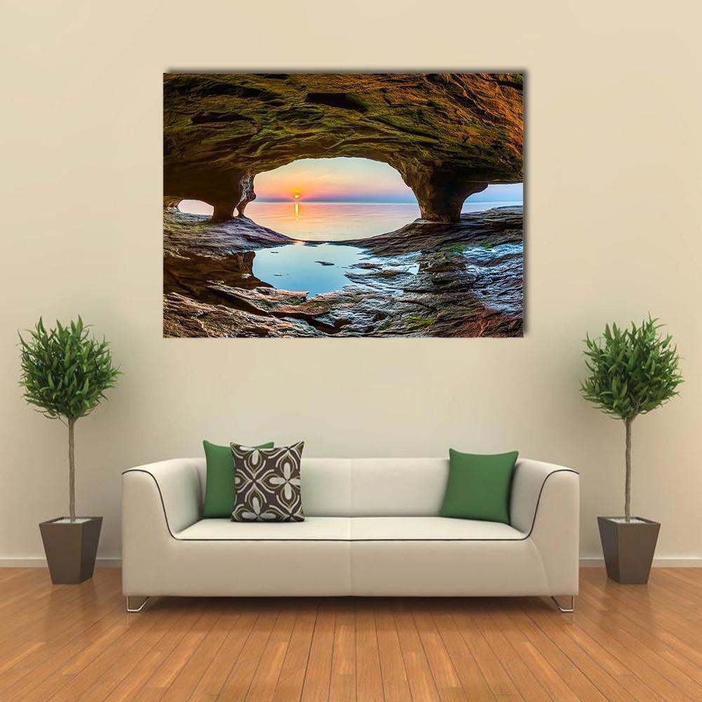 Sunset Over Lake Superior from Cave Canvas Wall Art in brown, orange and blue, single panel hung on a wall