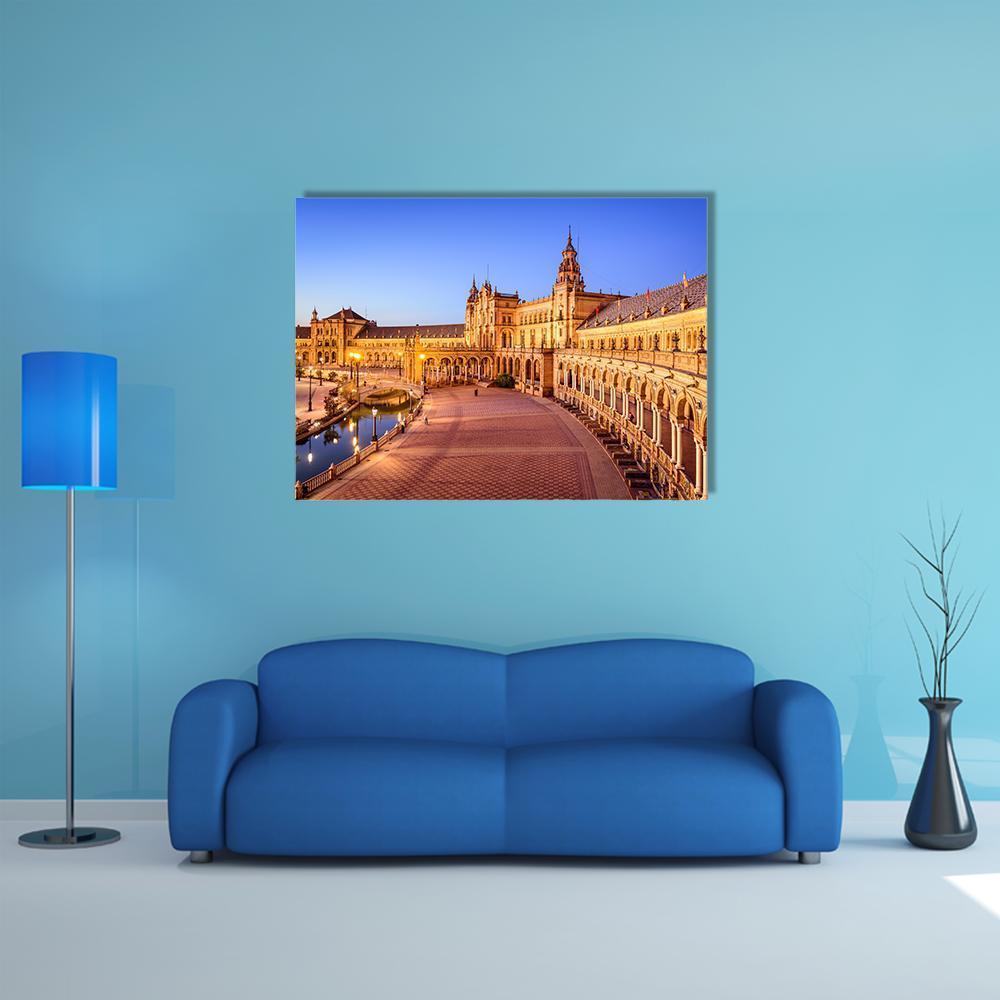 Spanish Square in Seville Canvas Wall Art in gold, orange and blue, single panel hung on a wall