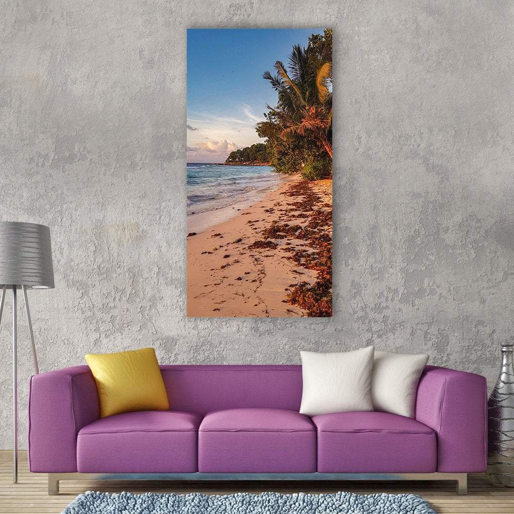 Seychelles Beach with Palm Trees Vertical Canvas Wall Art in beige, green and blue, single vertical panel hung on a wall