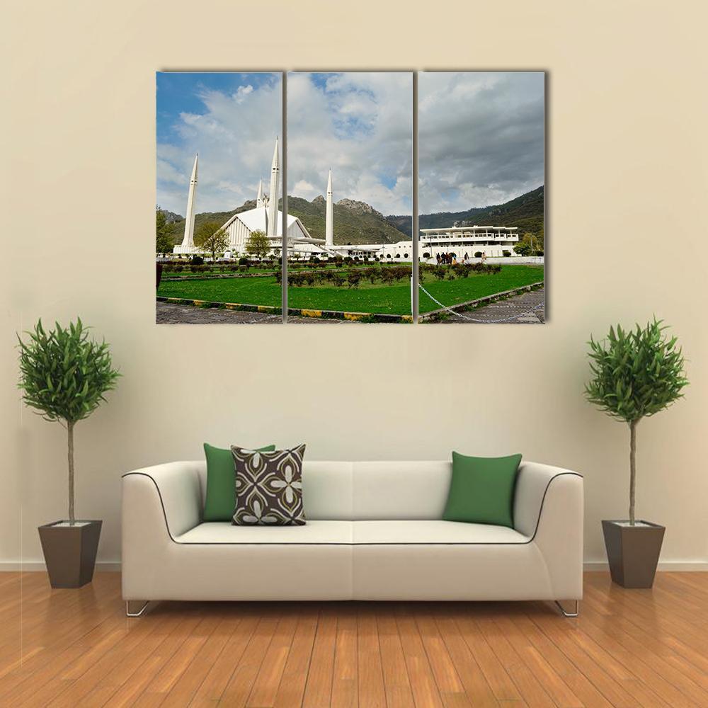 Shah Faisal Mosque Under Cloudy Sky Canvas Wall Art in white, green and blue, 3 panel horizontal set hung on a wall