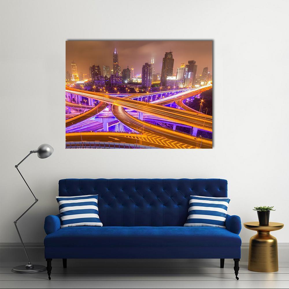 Shanghai Night Interchange with Light Trails Canvas Wall Art in orange, yellow and purple, single panel hung on a wall