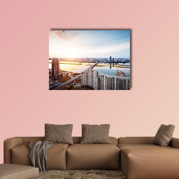 Shanghai Interchange at Sunset Canvas Wall Art in orange, yellow and blue, single panel hung on a wall