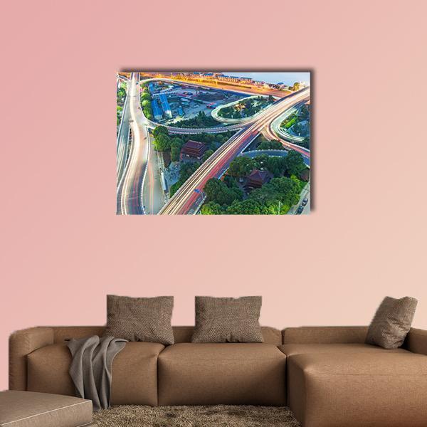 Shanghai Interchange Overpass at Night Canvas Wall Art in gray, orange and green, single panel hung on a wall