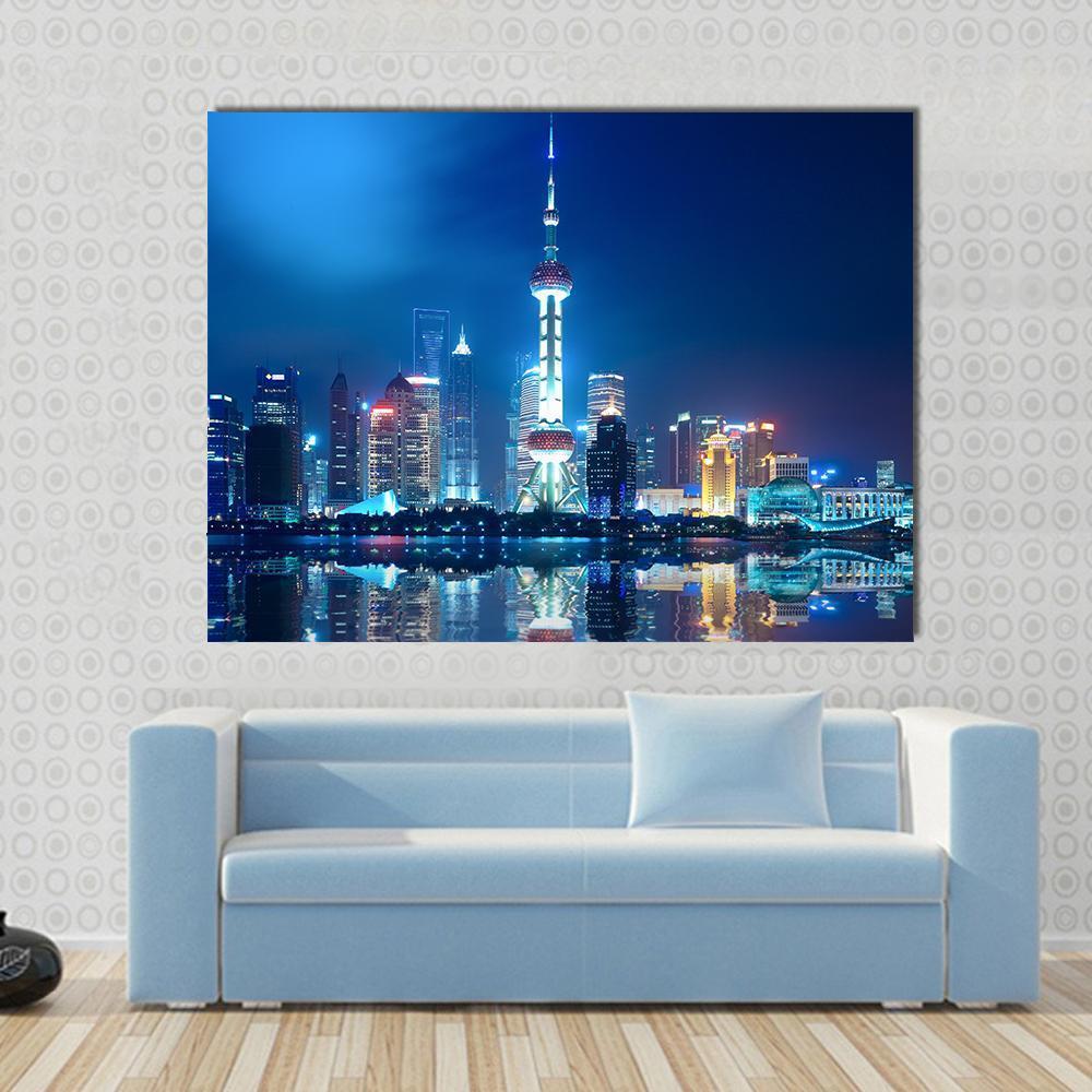 Shanghai Skyline with Reflection at Night Canvas Wall Art in blue and navy, single panel hung on a wall
