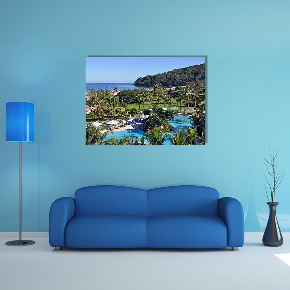 Aerial View of Tropical Resort Pool Canvas Wall Art in green and blue, single panel hung on a wall