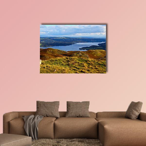 Sheep Overlooking Lake and Rolling Hills Canvas Wall Art in brown, green and blue, single panel hung on a wall