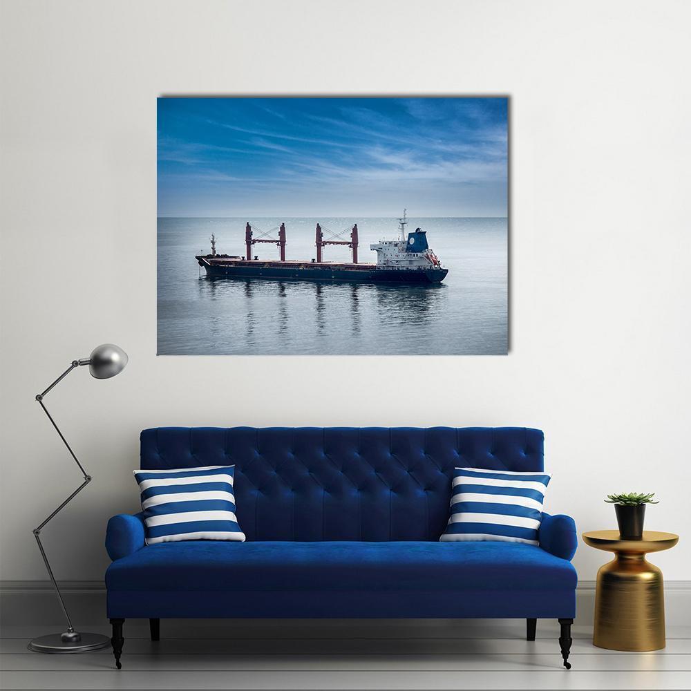 Cargo Ship with Red Cranes Canvas Wall Art in gray and blue, single panel hung on a wall