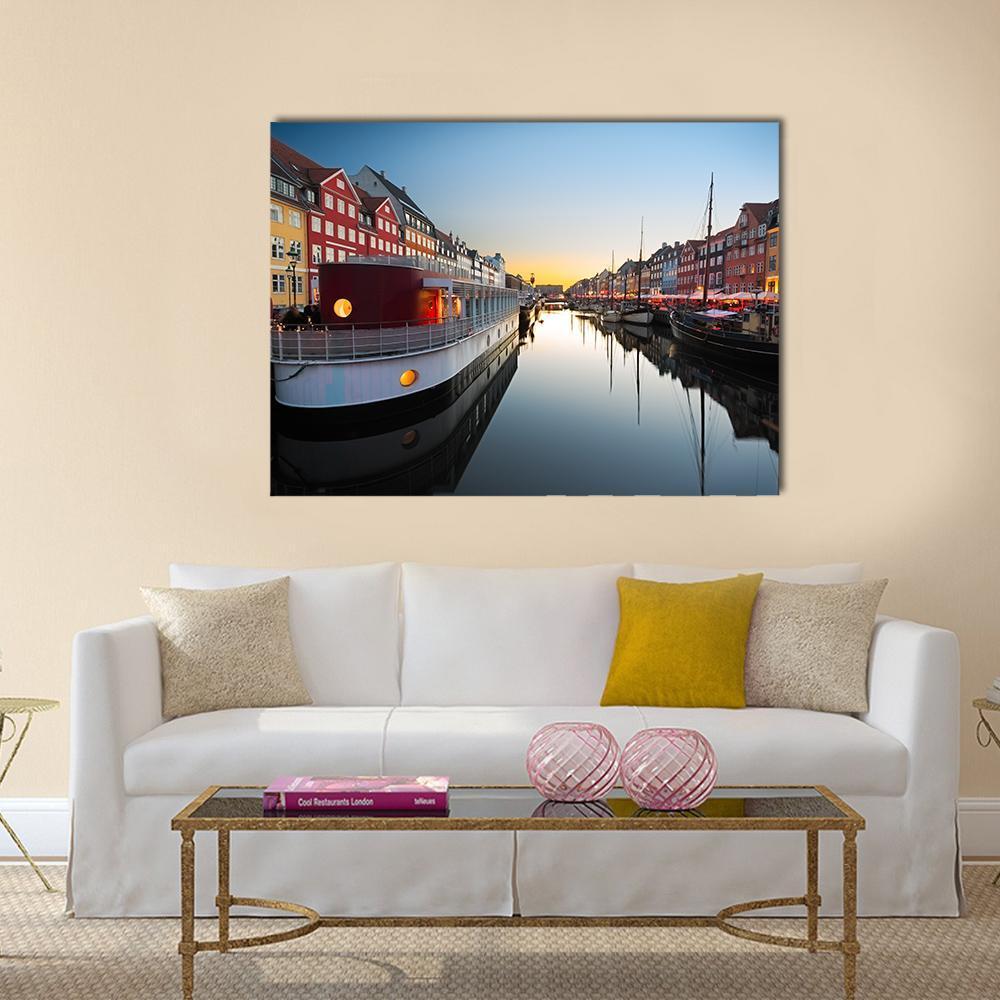 Boats in Nyhavn at Sunset Canvas Wall Art in red, orange and blue, single panel hung on a wall
