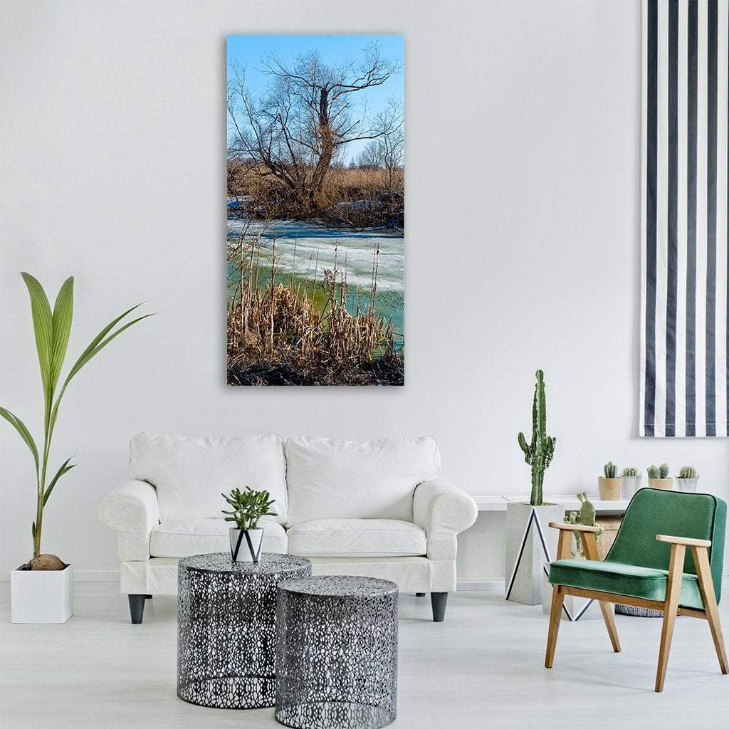 Siberian Autumn Shoreline Vertical Canvas Wall Art in beige, brown and blue, single vertical panel hung on a wall
