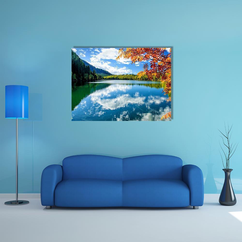 Siberia Lake with Reflection Canvas Wall Art in orange, green and blue, single panel hung on a wall